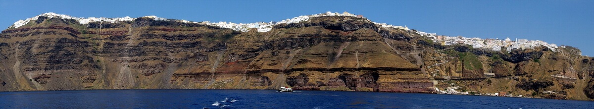 Panoramic view of Santorini with Fira, Firostefani, and Imerovigli over the sheer caldera
